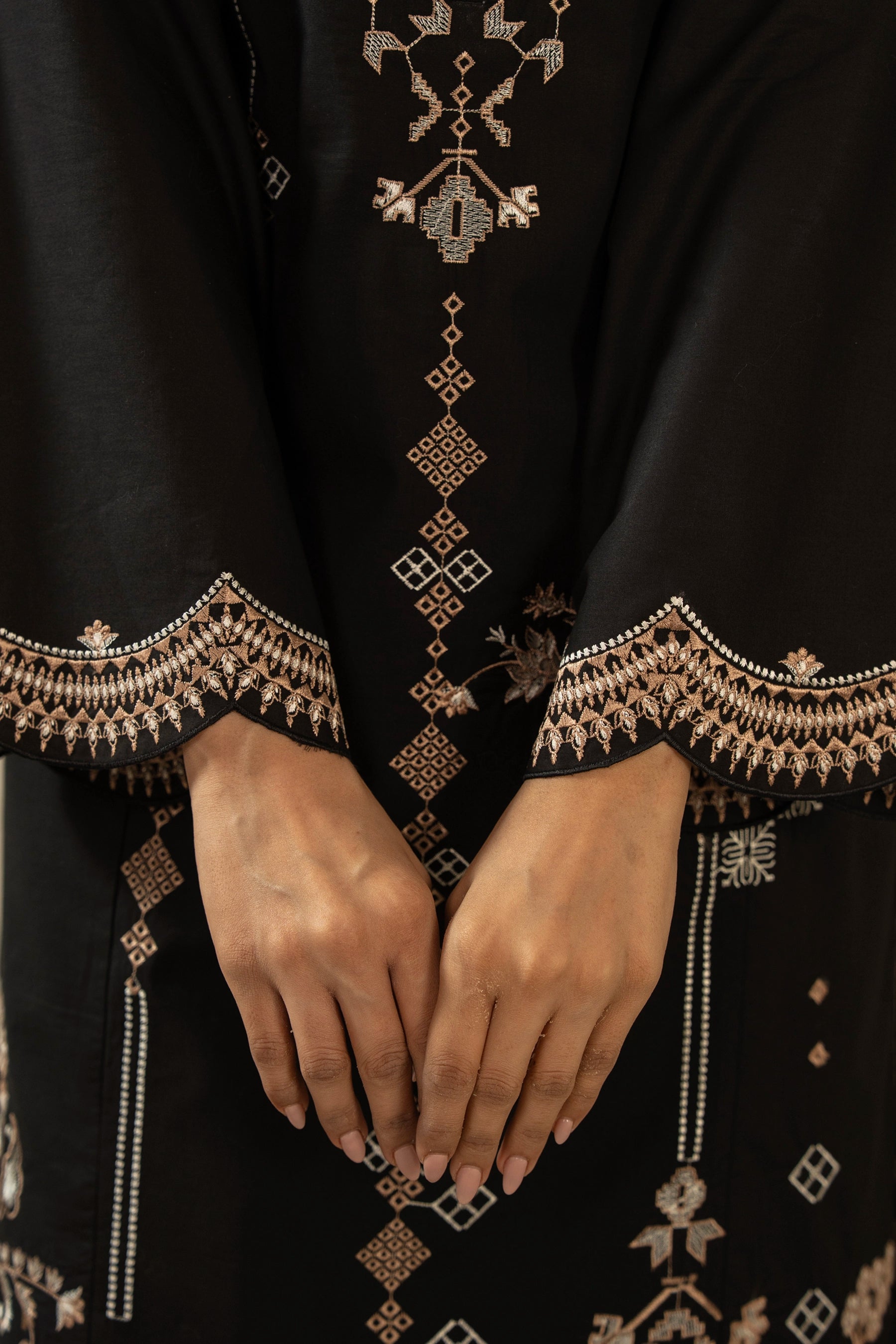 Premium stitched 3-piece black cambric suit displaying a mix of fine prints and embroidery, complete with a dupatta and matching trouser