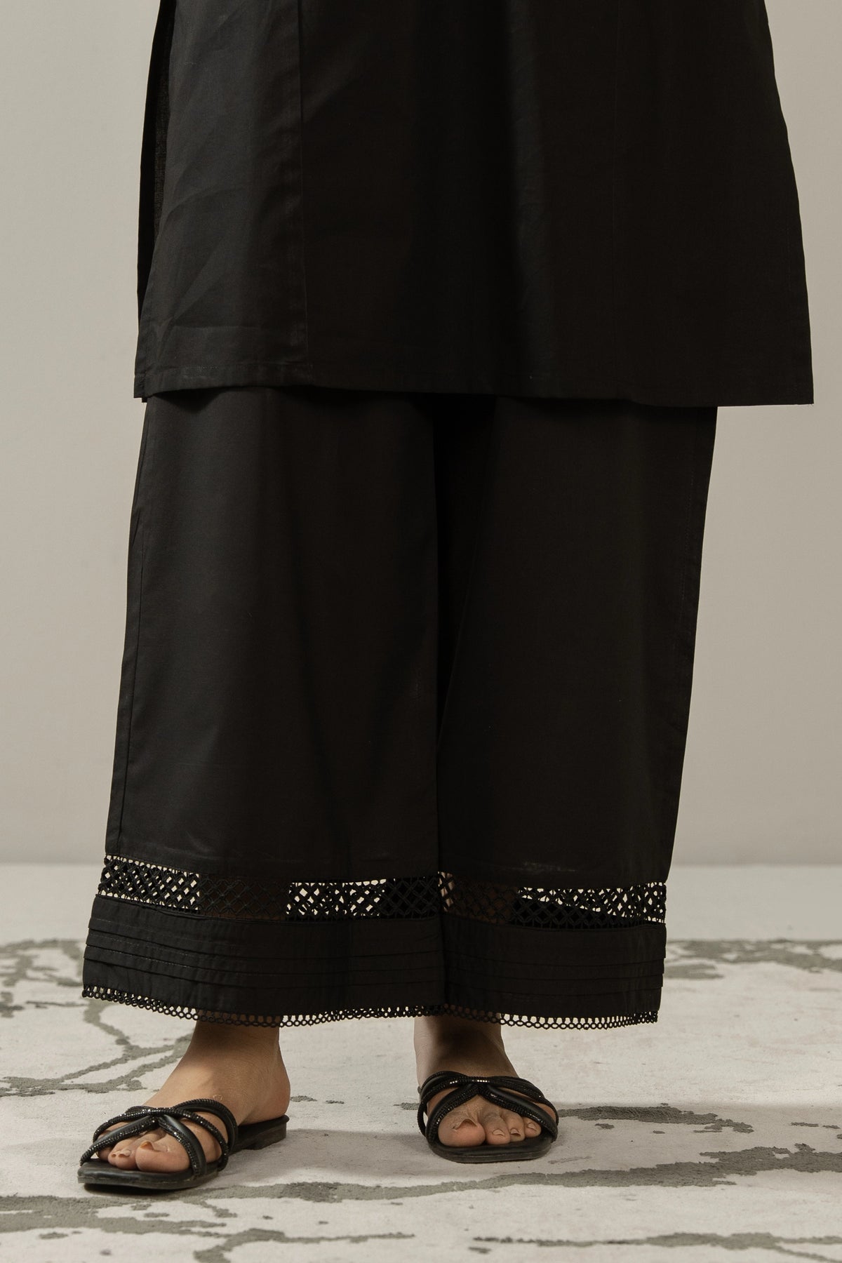 Contemporary black stitched cambric culottes featuring custom paneling and modern design elements.