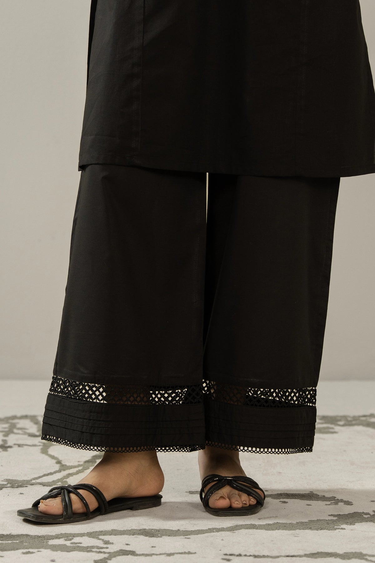 Contemporary black stitched cambric culottes featuring custom paneling and modern design elements.