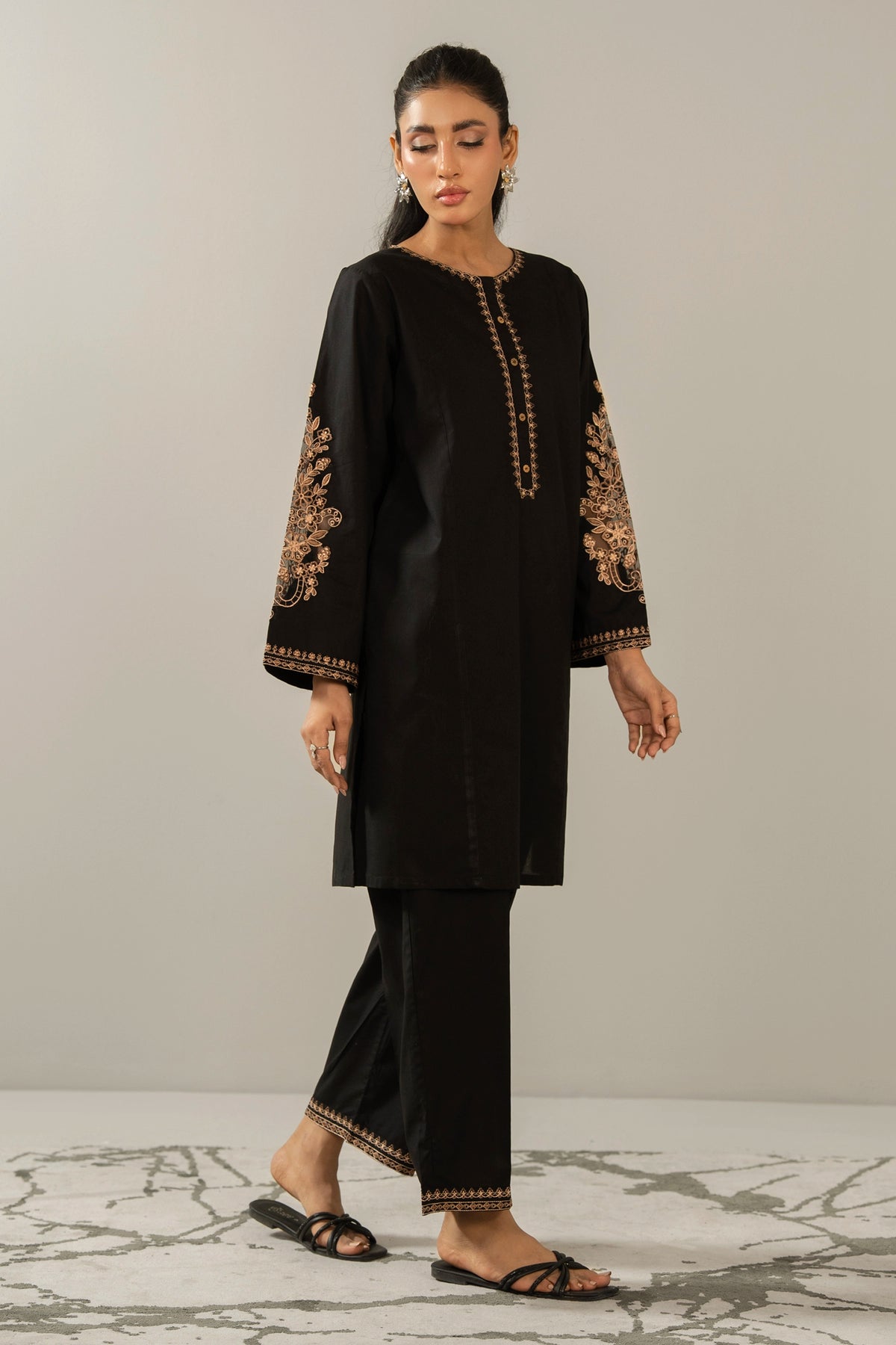 Elegant stitched 2-piece black cambric suit with intricate embroidery detail on the shirt paired with matching bottom trousers