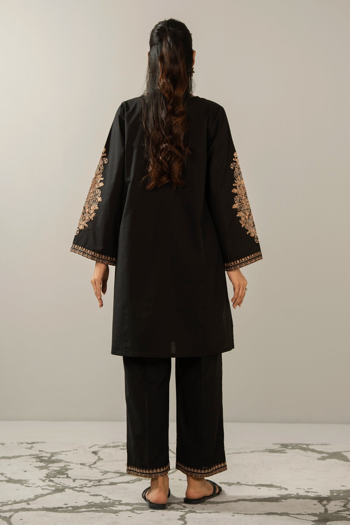 Elegant stitched 2-piece black cambric suit with intricate embroidery detail on the shirt paired with matching bottom trousers