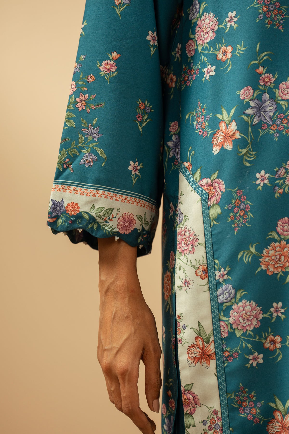 Elegant stitched 3-piece teal poly cambric suit with rich print arrangements, including a printed dupatta and matching trousers