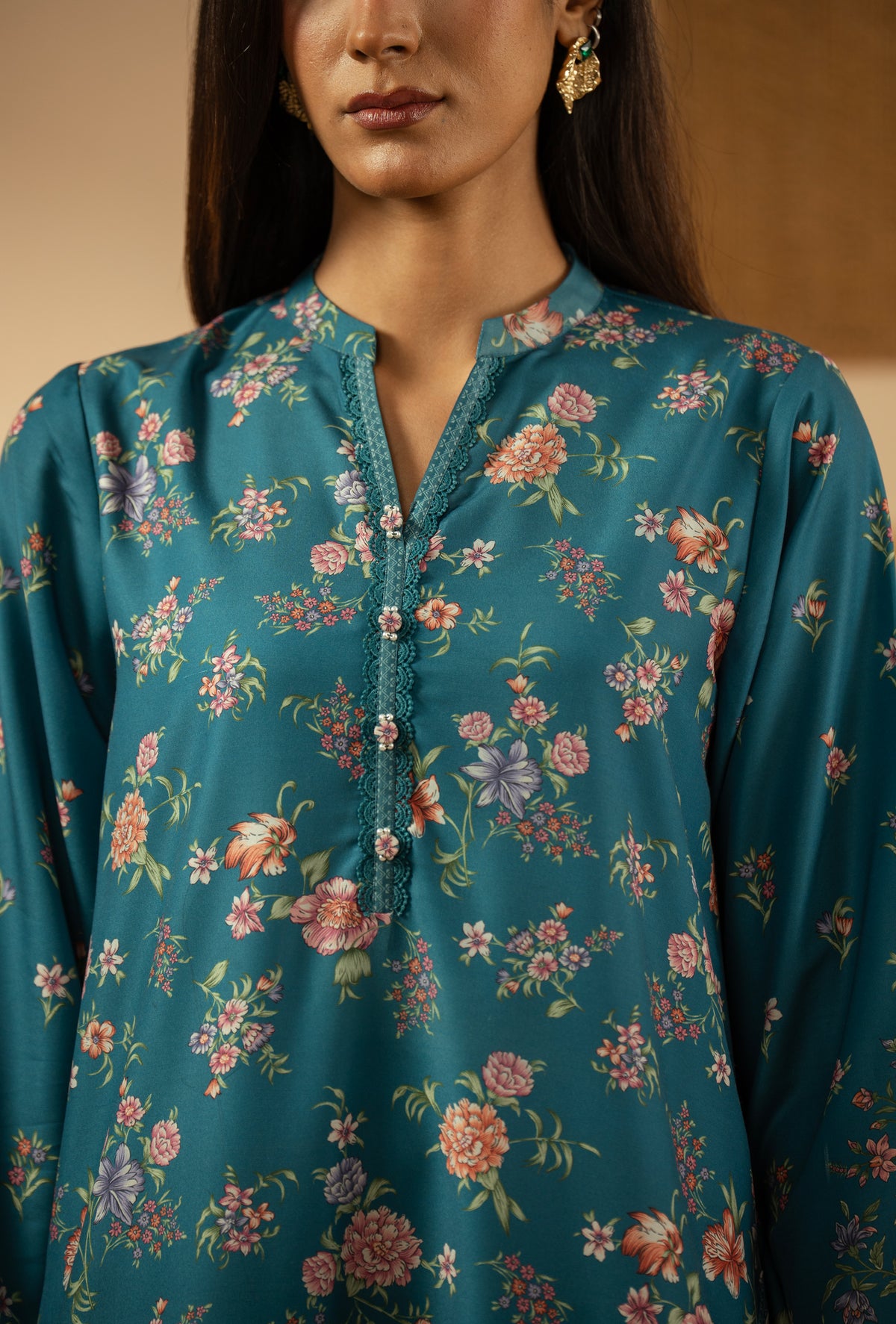 Elegant stitched 3-piece teal poly cambric suit with rich print arrangements, including a printed dupatta and matching trousers