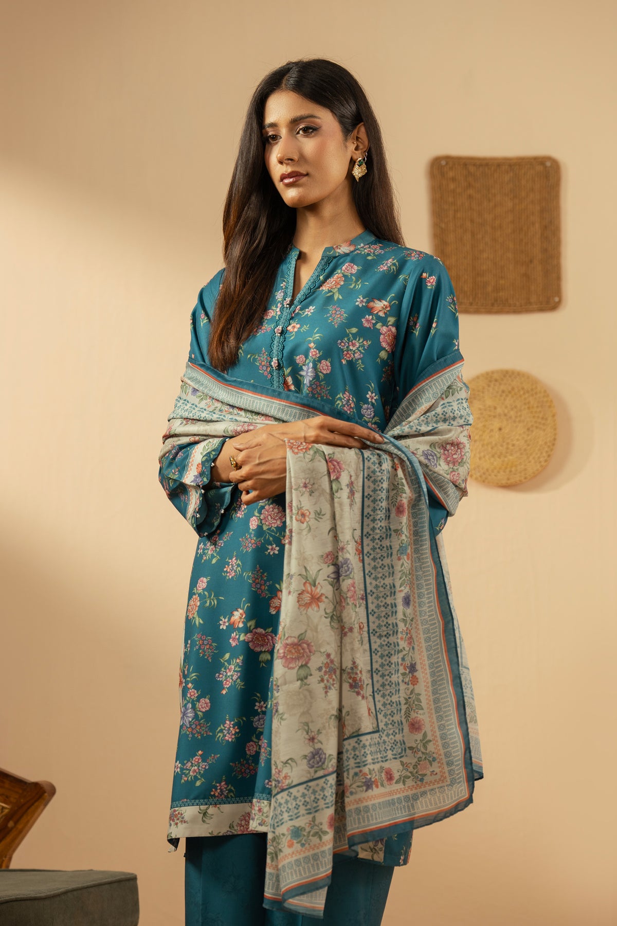 Elegant stitched 3-piece teal poly cambric suit with rich print arrangements, including a printed dupatta and matching trousers