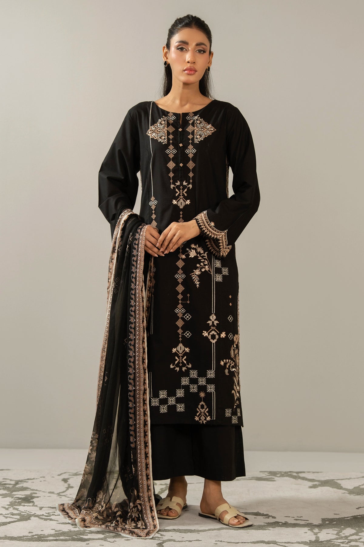 Premium stitched 3-piece black cambric suit displaying a mix of fine prints and embroidery, complete with a dupatta and matching trouser