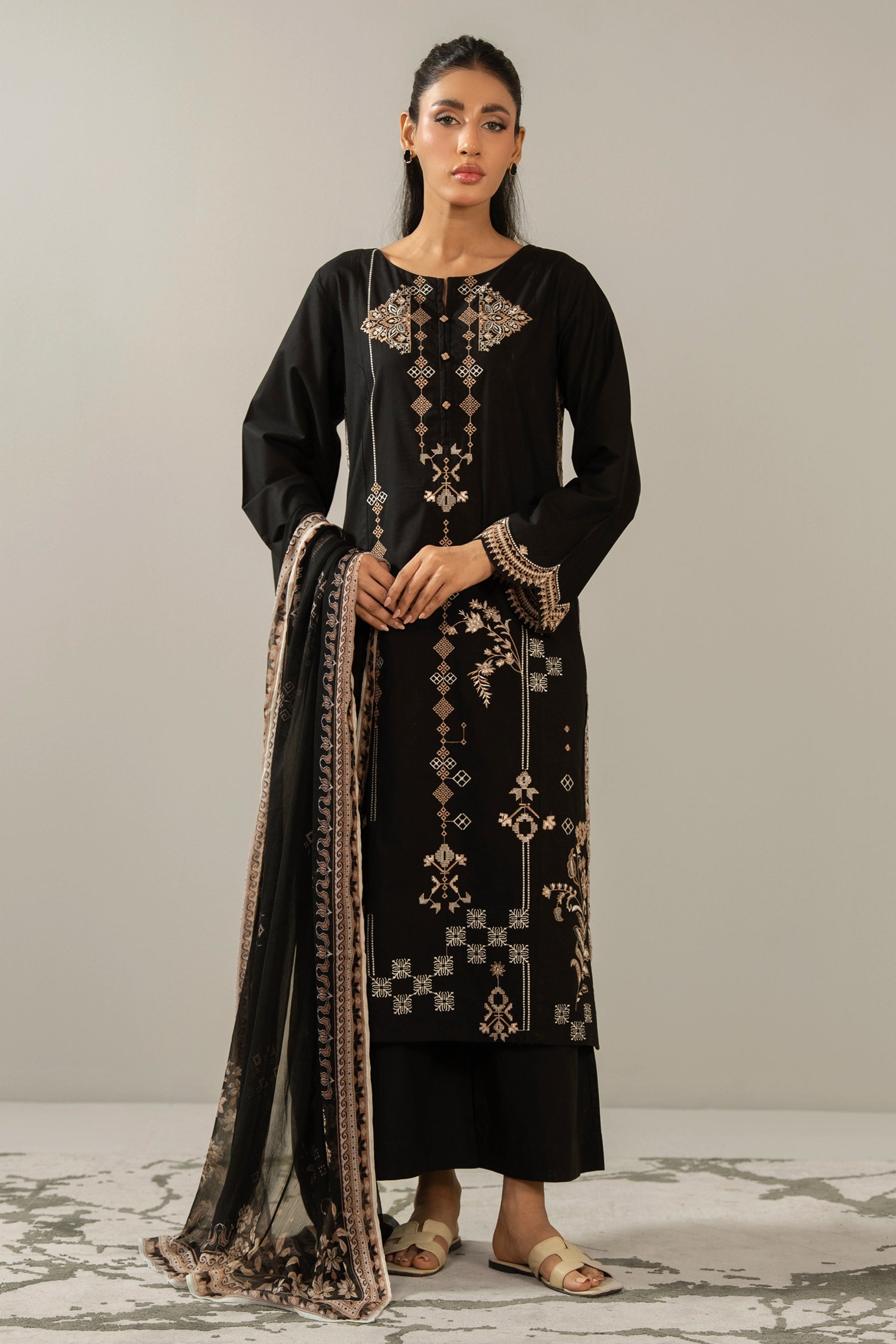 Premium stitched 3-piece black cambric suit displaying a mix of fine prints and embroidery, complete with a dupatta and matching trouser