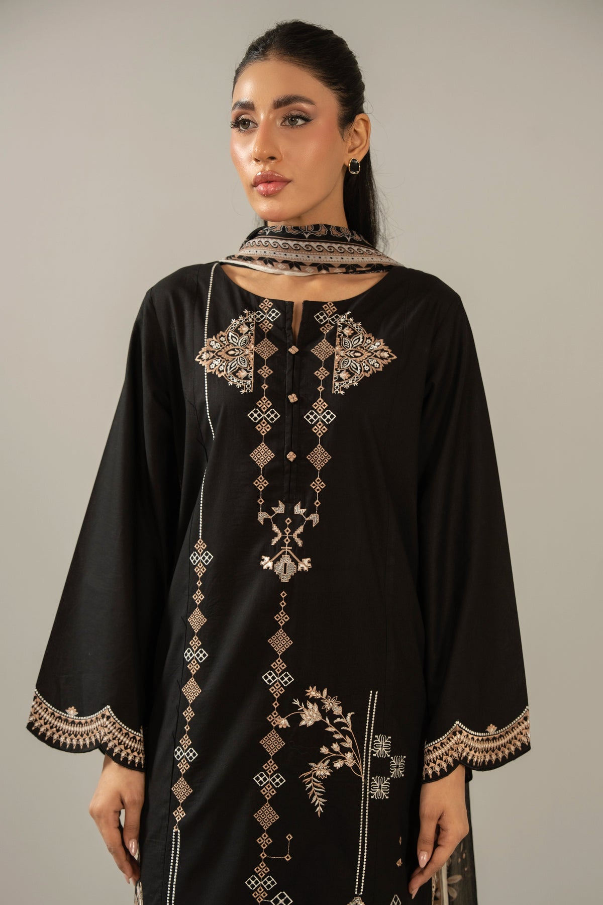 Premium stitched 3-piece black cambric suit displaying a mix of fine prints and embroidery, complete with a dupatta and matching trouser