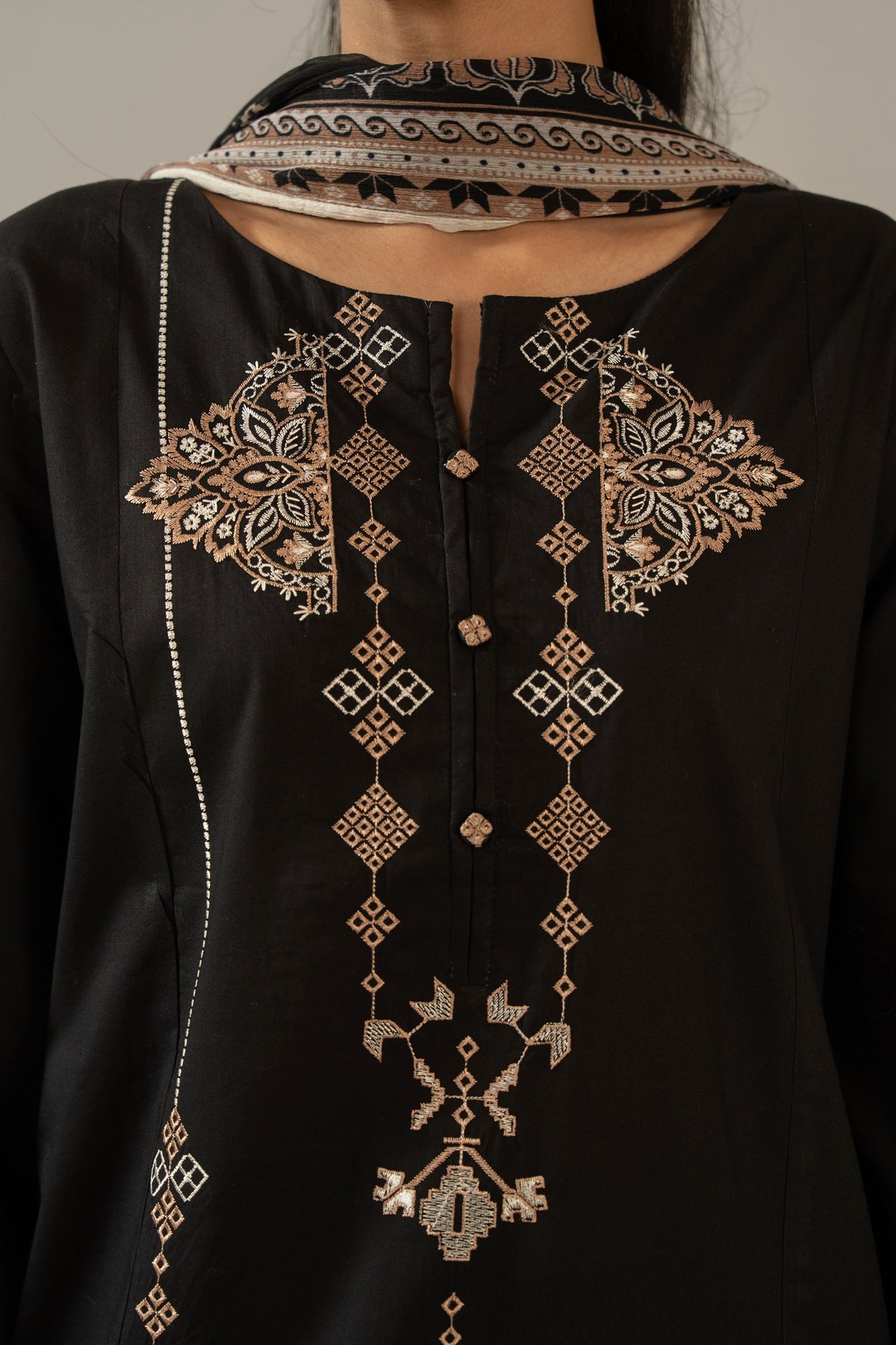 Premium stitched 3-piece black cambric suit displaying a mix of fine prints and embroidery, complete with a dupatta and matching trouser
