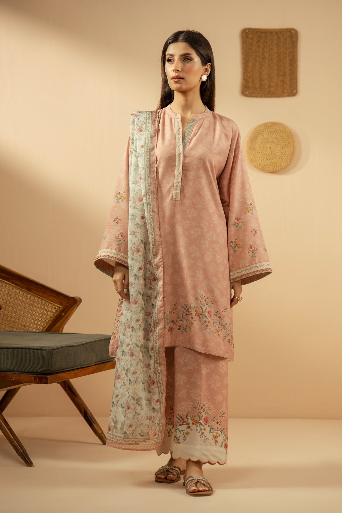 Soft peach stitched 3-piece poly cambric suit featuring intricate floral print layouts, matching dupatta, and trousers