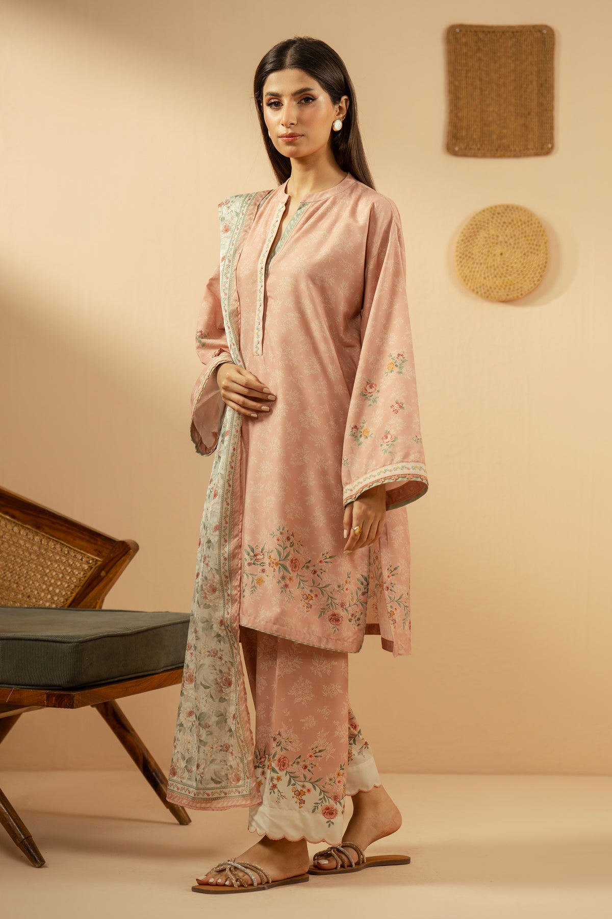 Soft peach stitched 3-piece poly cambric suit featuring intricate floral print layouts, matching dupatta, and trousers