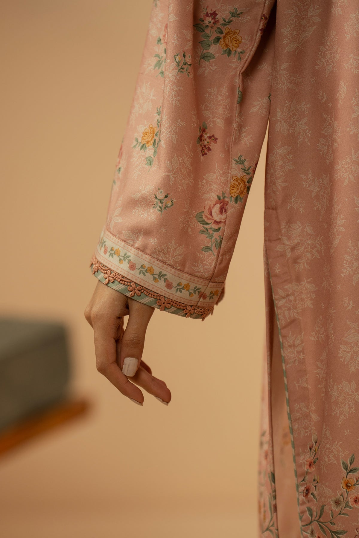 Soft peach stitched 3-piece poly cambric suit featuring intricate floral print layouts, matching dupatta, and trousers