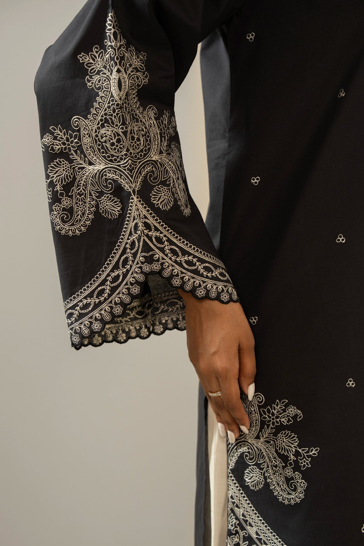 Sophisticated black embroidered cambric 2-piece stitched suit showcasing elegant neckline detailing and matching trousers