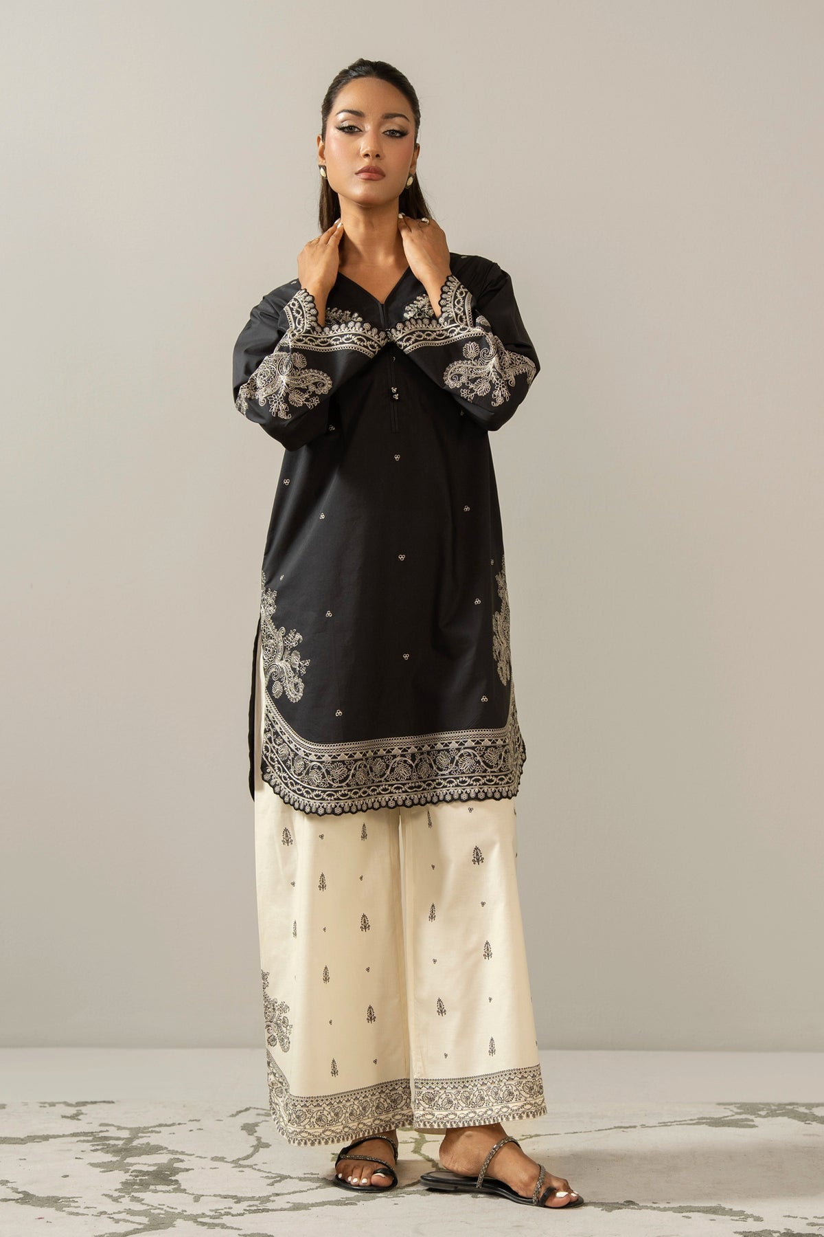 Sophisticated black embroidered cambric 2-piece stitched suit showcasing elegant neckline detailing and matching trousers