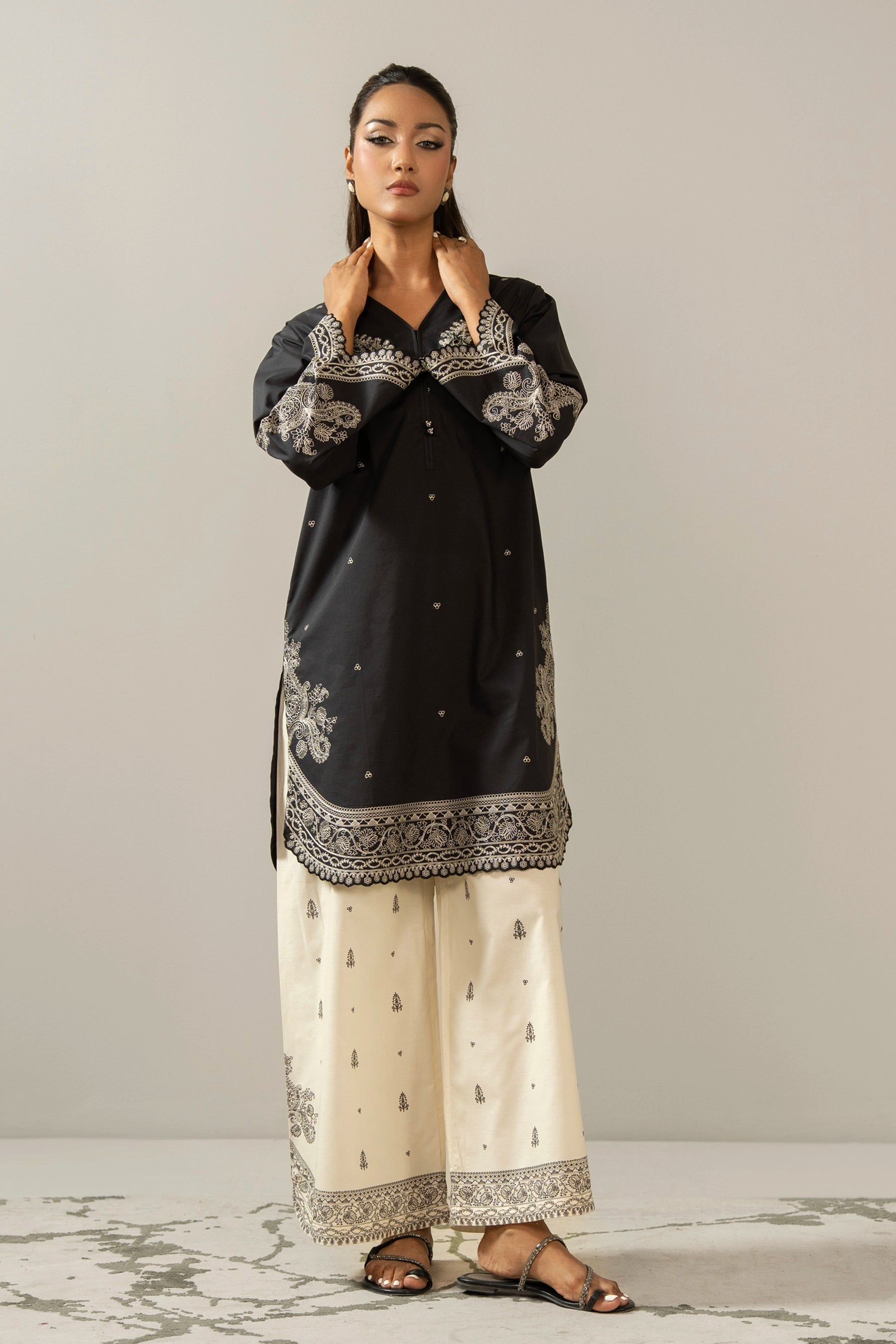 Sophisticated black embroidered cambric 2-piece stitched suit showcasing elegant neckline detailing and matching trousers