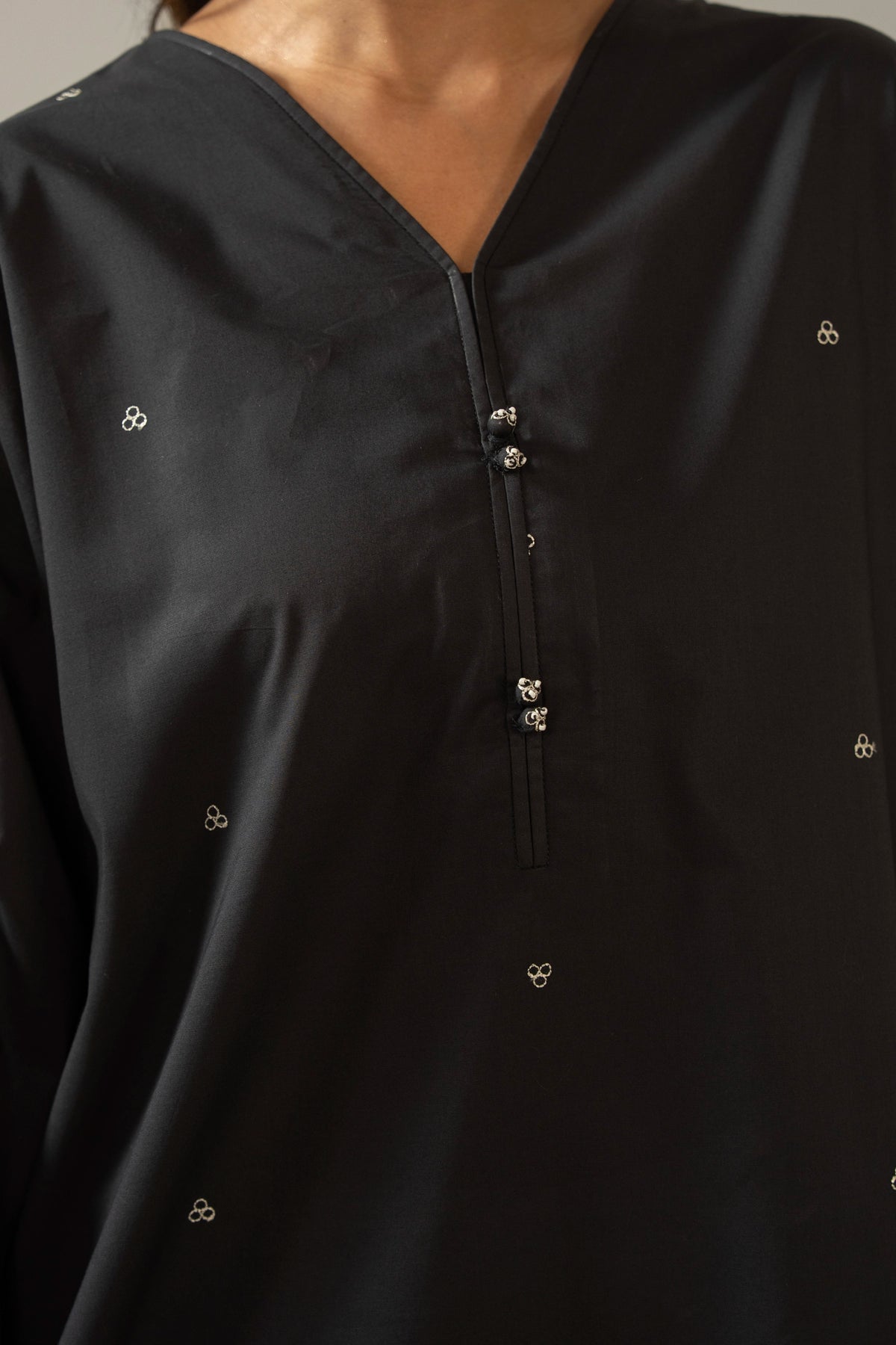 Sophisticated black embroidered cambric 2-piece stitched suit showcasing elegant neckline detailing and matching trousers