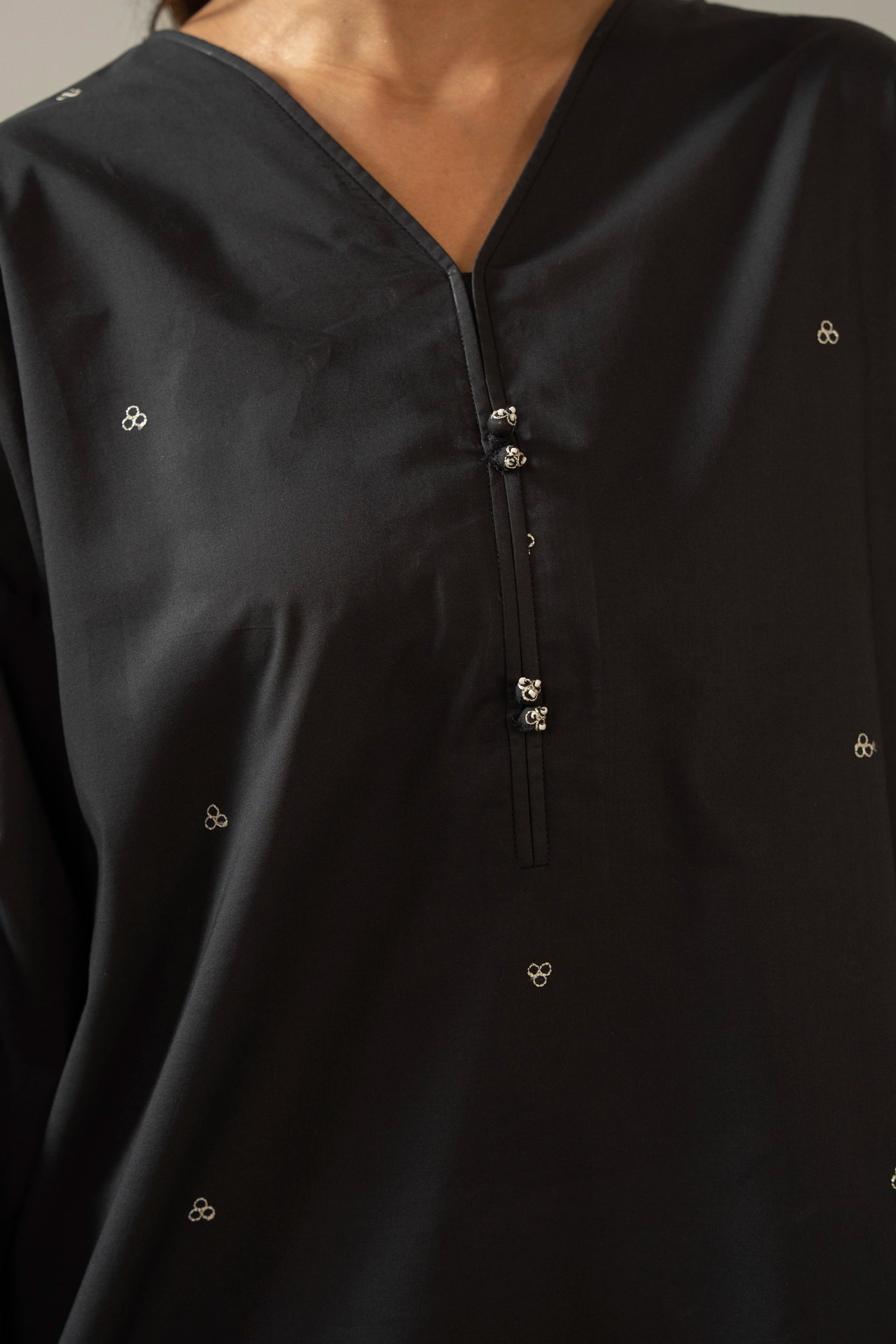 Sophisticated black embroidered cambric 2-piece stitched suit showcasing elegant neckline detailing and matching trousers