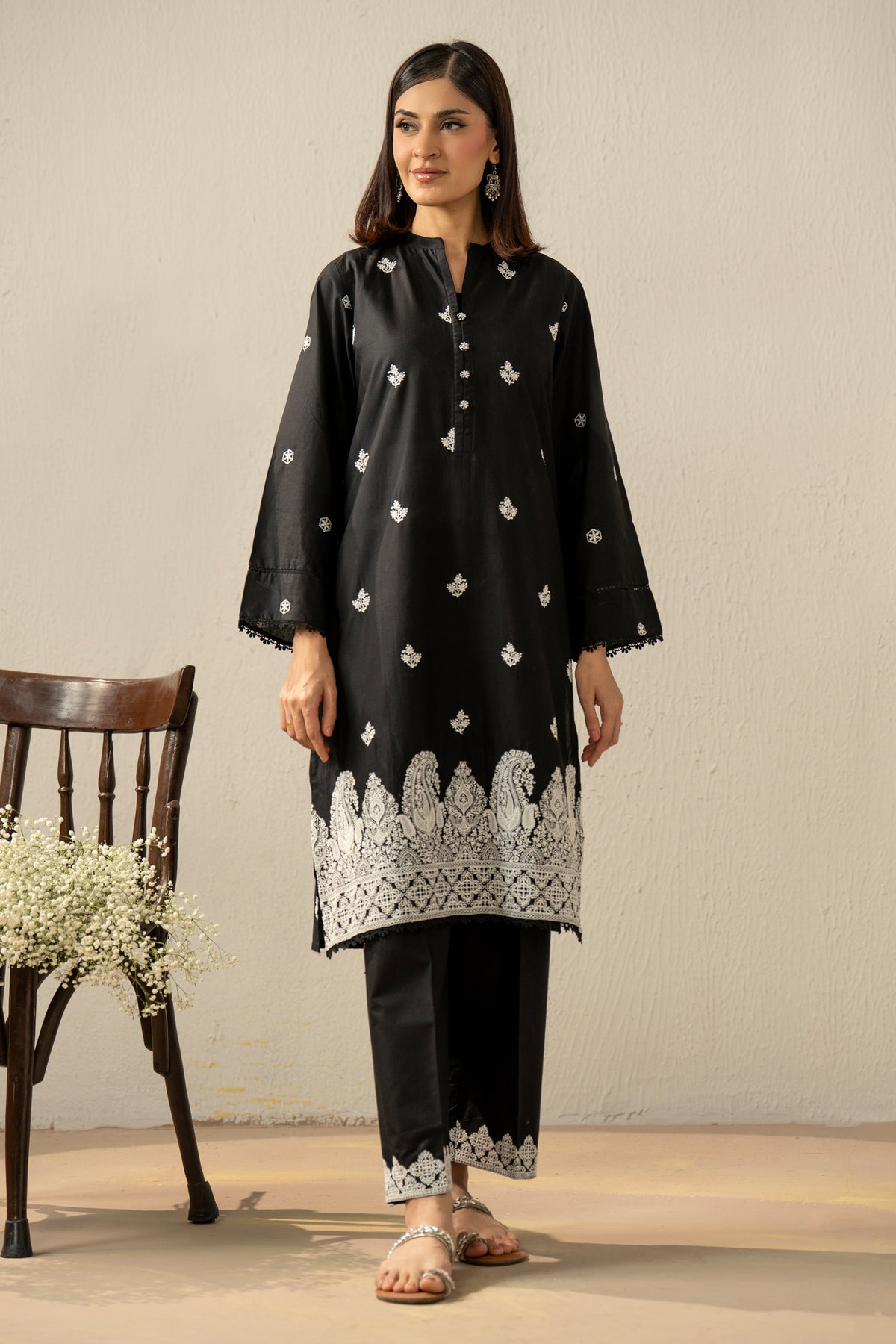 Stitched 2-piece black lawn suit featuring exquisite traditional Chikankari embroidery work on the shirt and trousers