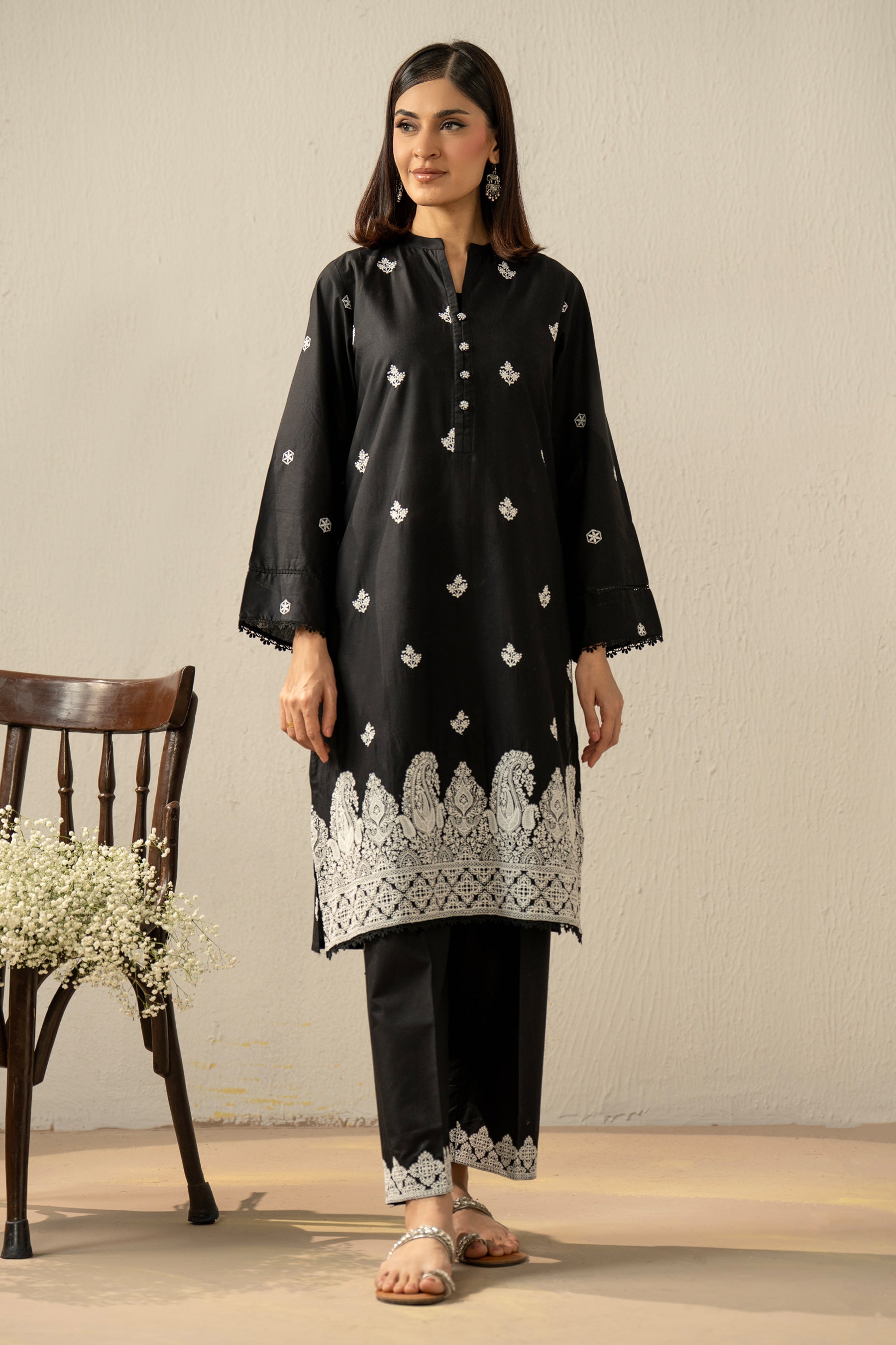 Stitched 2-piece black lawn suit featuring exquisite traditional Chikankari embroidery work on the shirt and trousers
