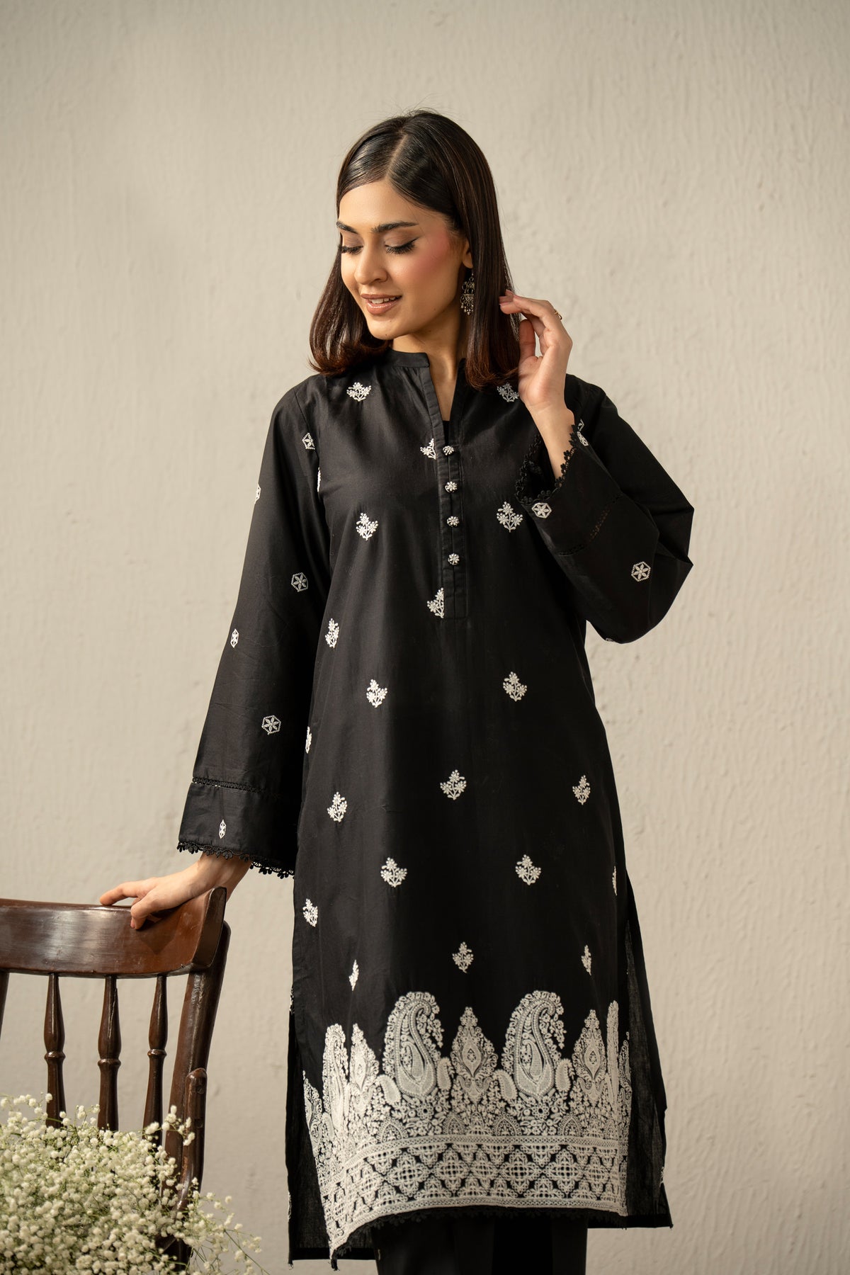 Stitched 2-piece black lawn suit featuring exquisite traditional Chikankari embroidery work on the shirt and trousers