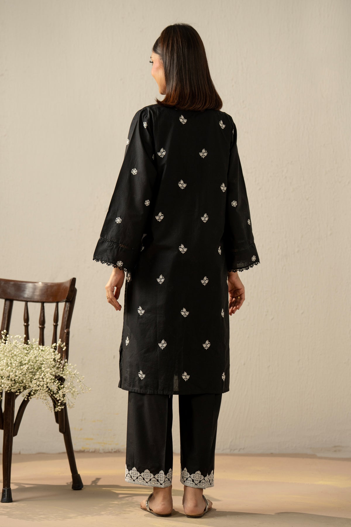 Stitched 2-piece black lawn suit featuring exquisite traditional Chikankari embroidery work on the shirt and trousers