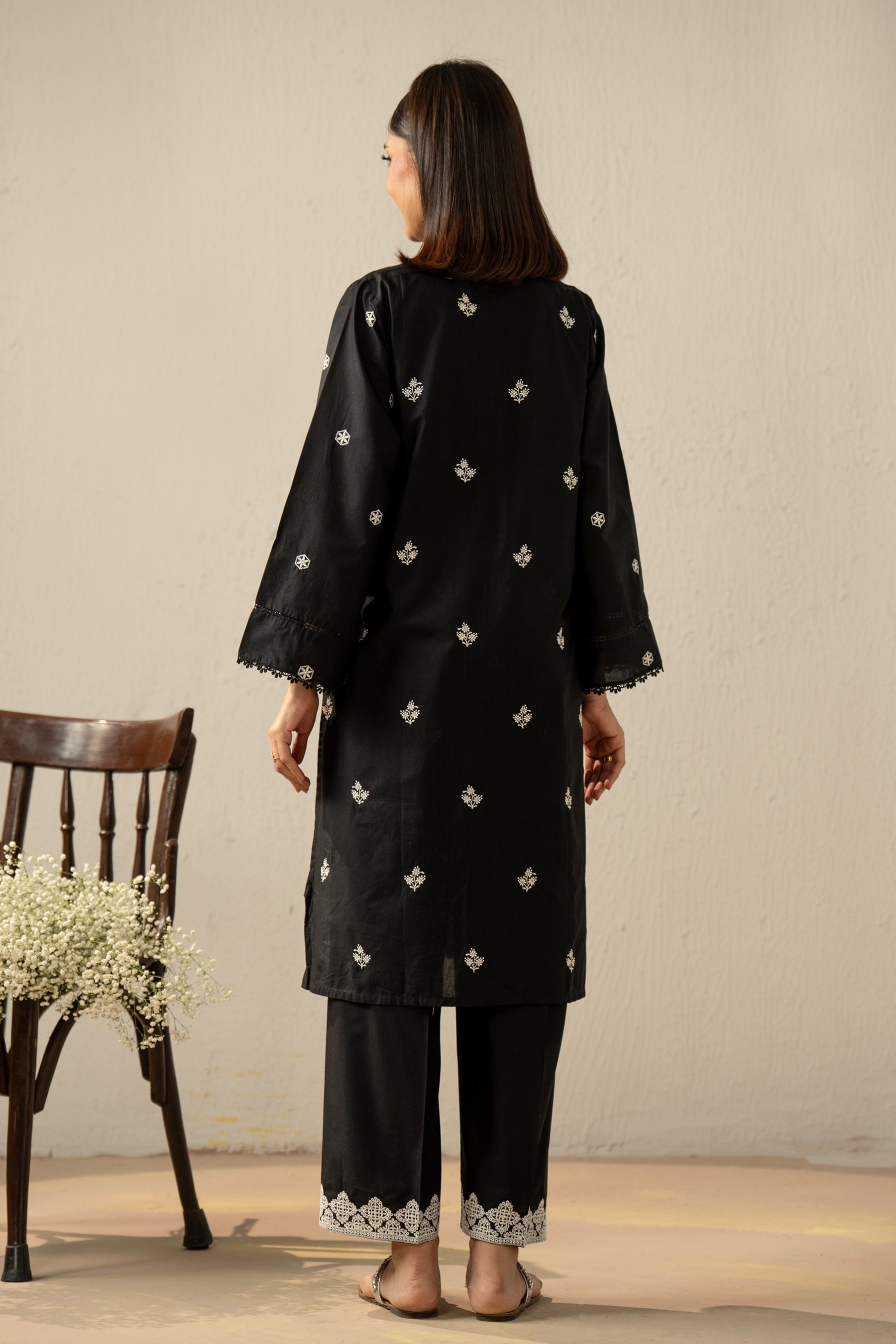 Stitched 2-piece black lawn suit featuring exquisite traditional Chikankari embroidery work on the shirt and trousers