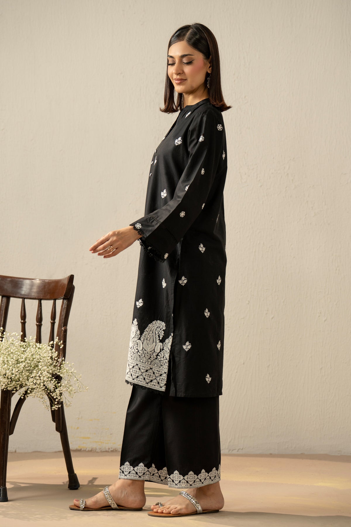 Stitched 2-piece black lawn suit featuring exquisite traditional Chikankari embroidery work on the shirt and trousers