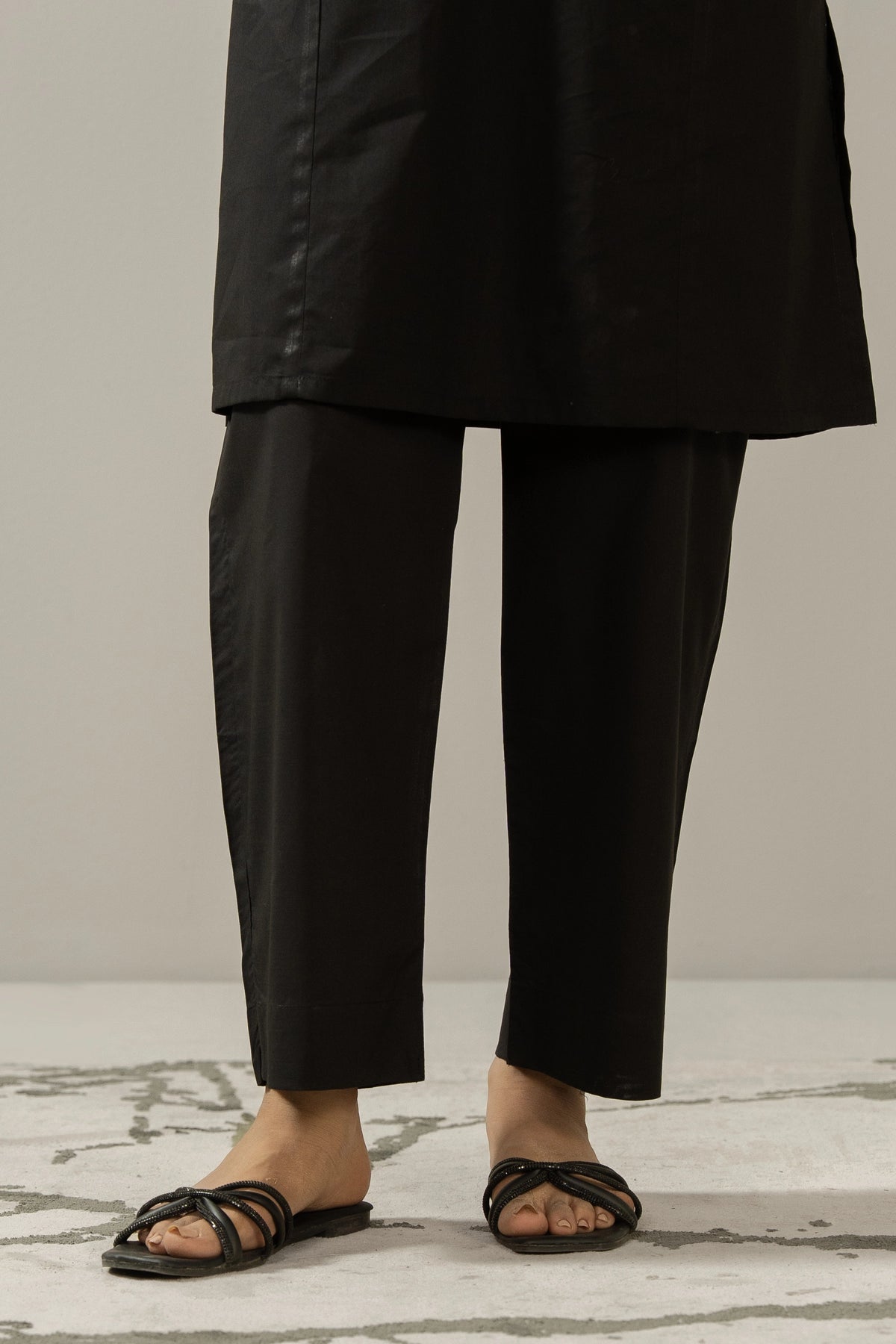 Trendy stylized black cambric straight pants with tailored details, perfect for versatile pairing