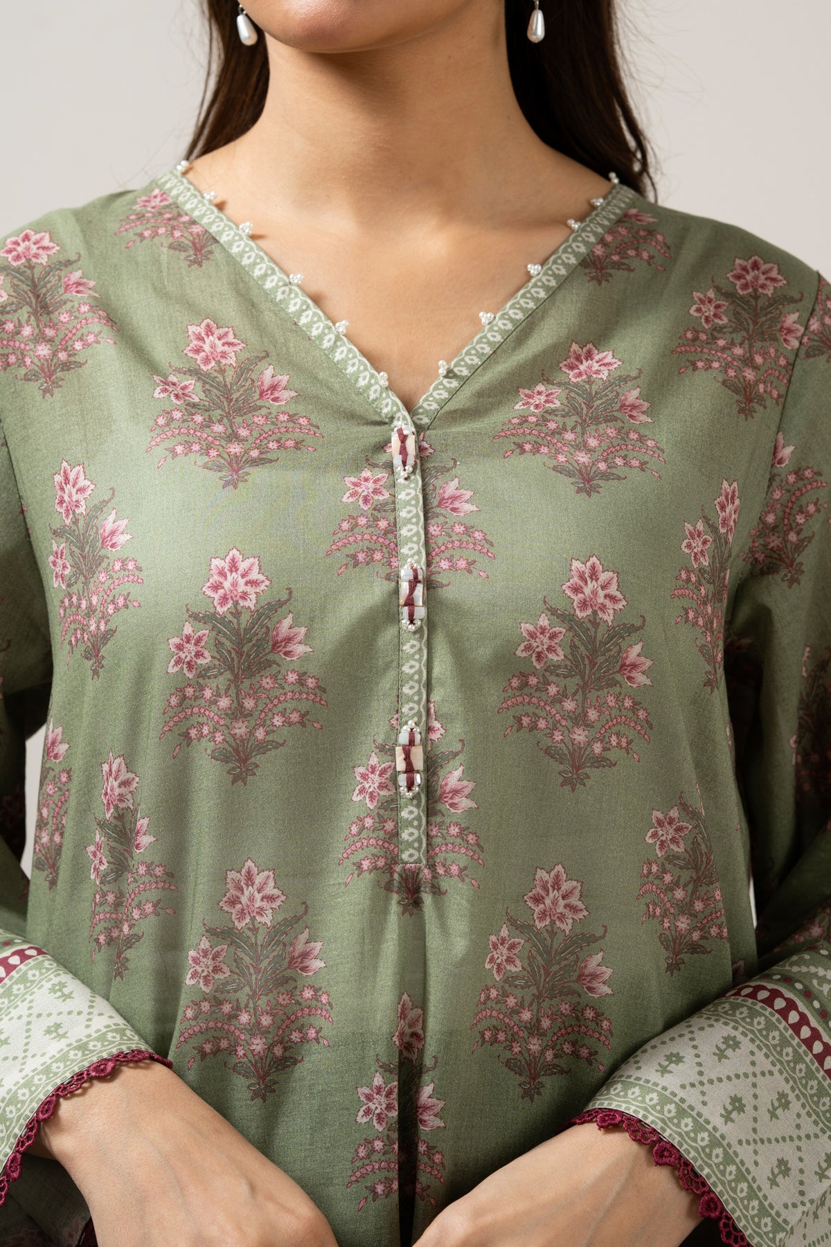 Emerald green 3-piece unstitched printed lawn suite showcasing clean structural geometric designs