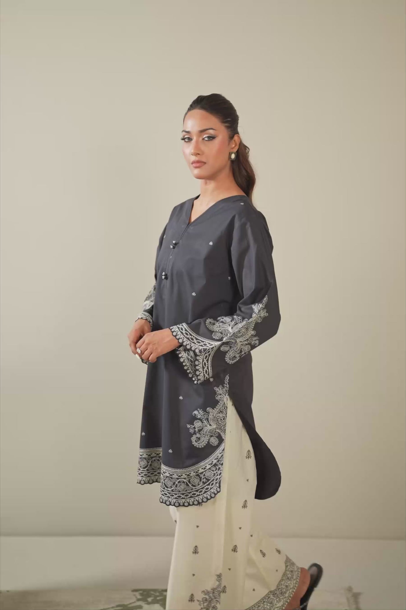 Sophisticated black embroidered cambric 2-piece stitched suit showcasing elegant neckline detailing and matching trousers